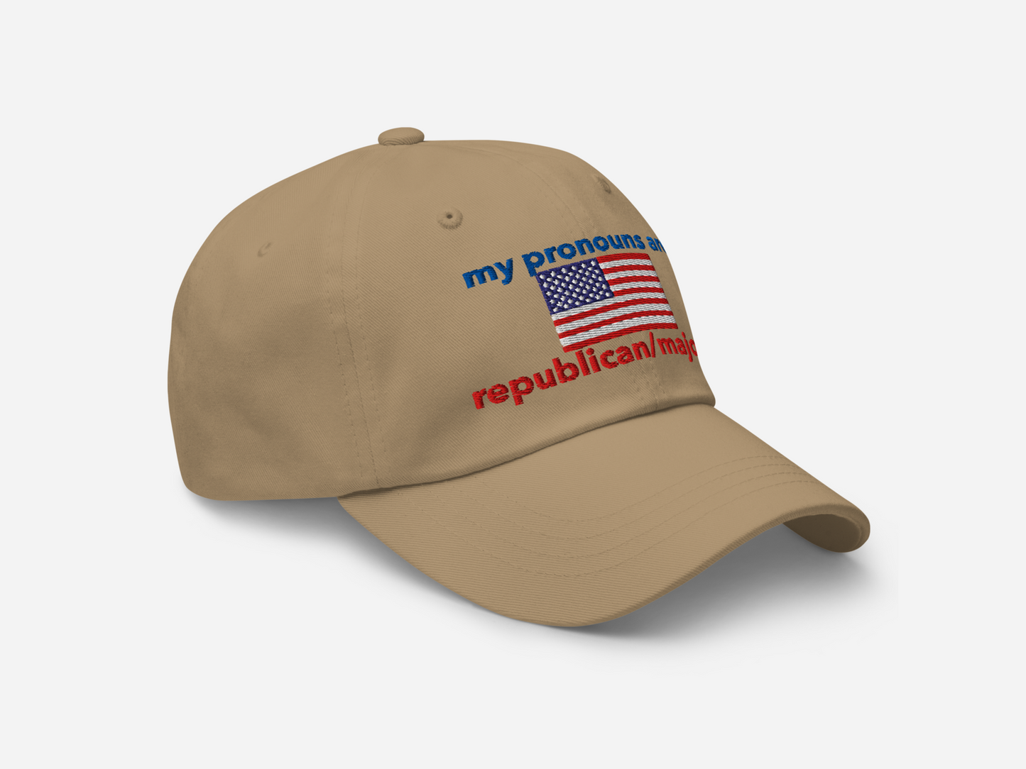 A khaki dad hat featuring "my pronouns are republican/majority" embroidery with detailed a American flag design, shown from the right-front angle, emphasizing the clean, adjustable strap, structured fit and highlighting the curved brim and stitching details